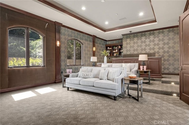 interior space featuring ornamental molding, light carpet, and a tray ceiling