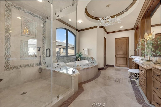 bathroom with an inviting chandelier, separate shower and tub, a tray ceiling, vanity, and ornamental molding