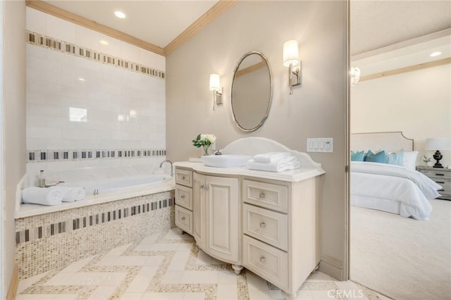 bathroom with vanity, crown molding, and tiled tub