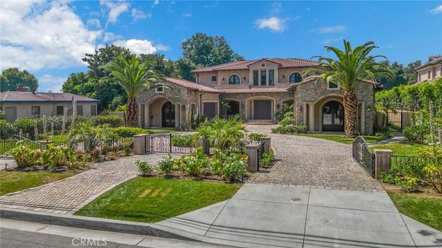 mediterranean / spanish house featuring a front lawn