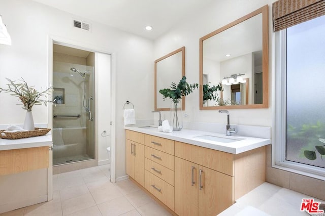 bathroom with tile patterned floors, toilet, vanity, and walk in shower