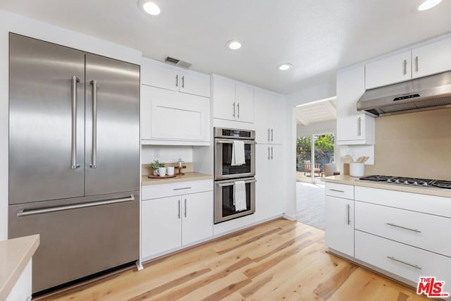 kitchen featuring white cabinets, light hardwood / wood-style floors, and stainless steel appliances