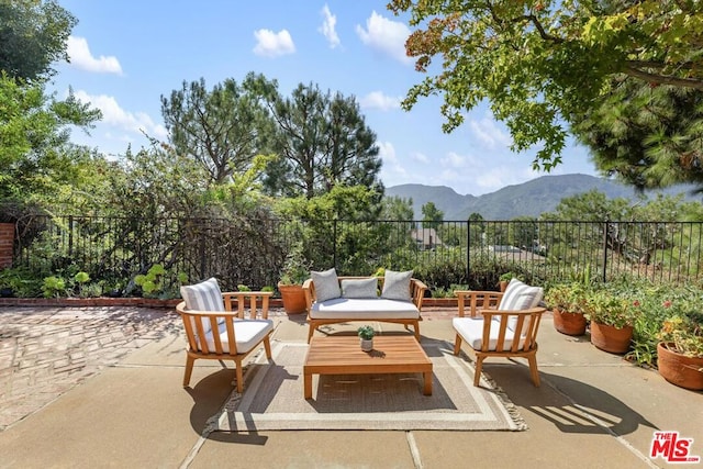 view of patio featuring a mountain view and an outdoor living space