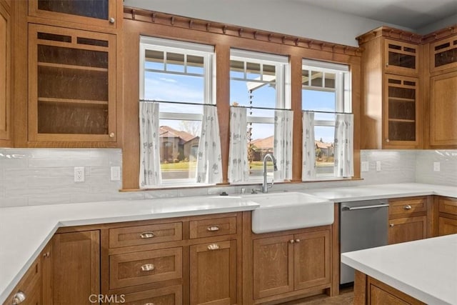 kitchen with dishwasher, tasteful backsplash, a wealth of natural light, and sink