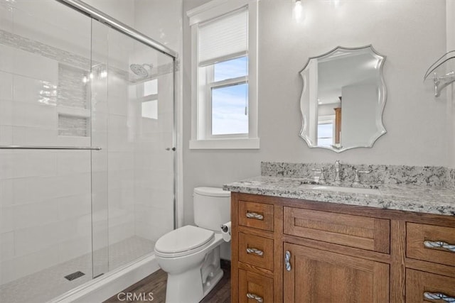 bathroom with vanity, wood-type flooring, an enclosed shower, and toilet