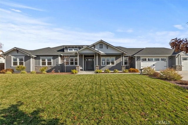 craftsman-style home featuring a front yard and a garage