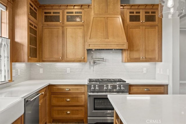 kitchen featuring custom exhaust hood, appliances with stainless steel finishes, and tasteful backsplash