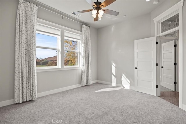 unfurnished bedroom with ceiling fan and carpet