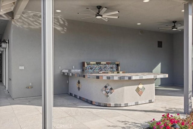 view of patio featuring ceiling fan