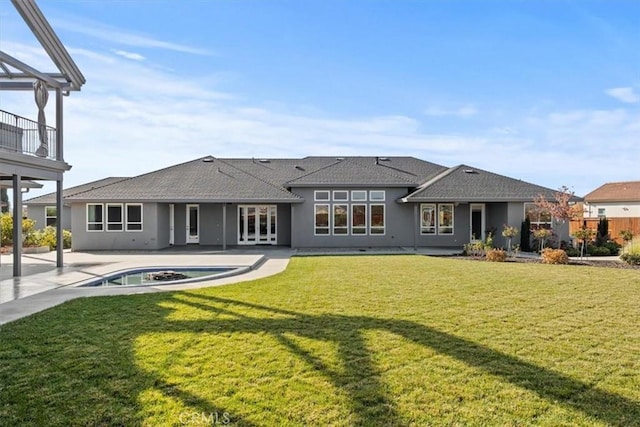 back of property featuring a patio area, a yard, and french doors