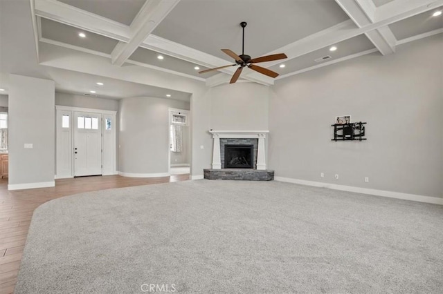 unfurnished living room featuring hardwood / wood-style floors, ceiling fan, beamed ceiling, and coffered ceiling