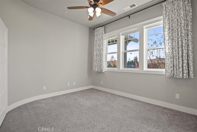 empty room featuring carpet floors and ceiling fan