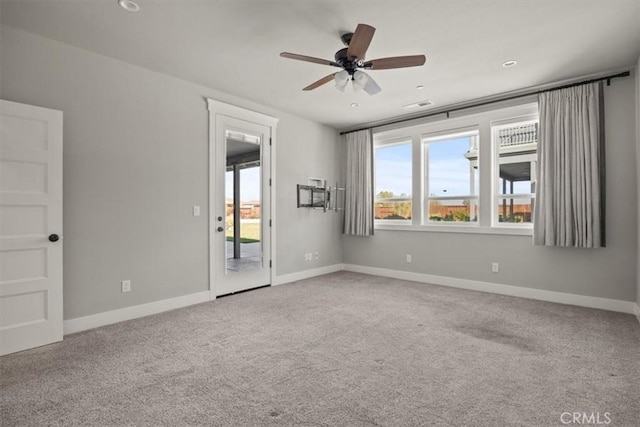 spare room with ceiling fan and carpet floors