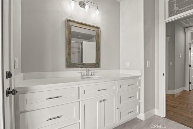 bathroom with hardwood / wood-style floors and vanity