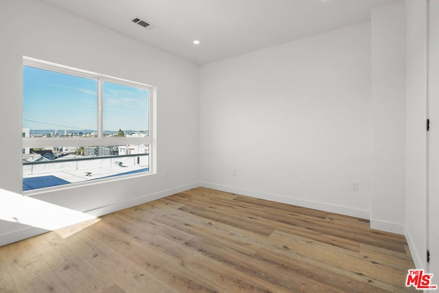 unfurnished room with light hardwood / wood-style flooring