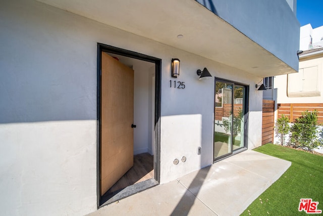 entrance to property with a patio