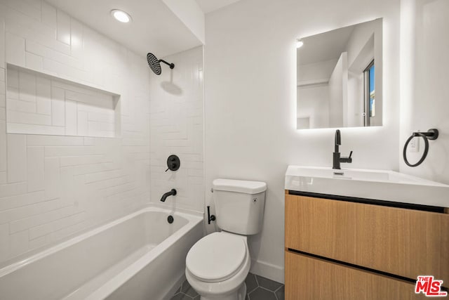 full bathroom with tile patterned flooring, vanity, toilet, and tiled shower / bath combo