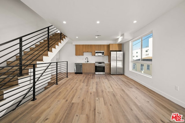 kitchen featuring light hardwood / wood-style floors, sink, and appliances with stainless steel finishes