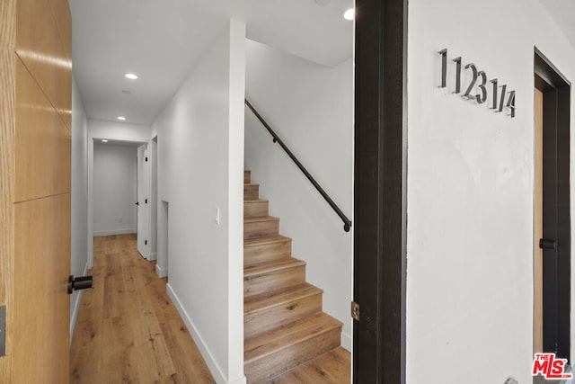 stairs with hardwood / wood-style floors