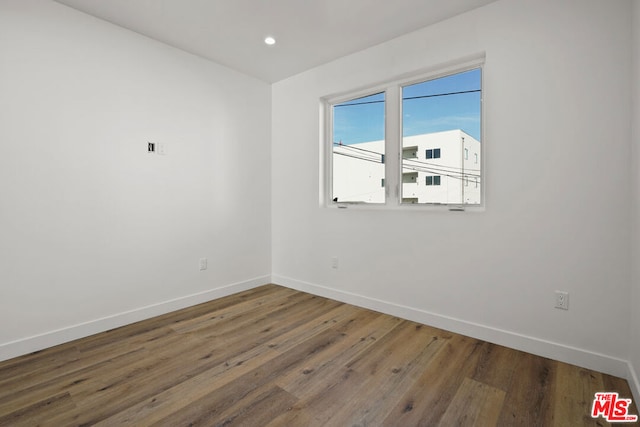 spare room featuring dark wood-type flooring