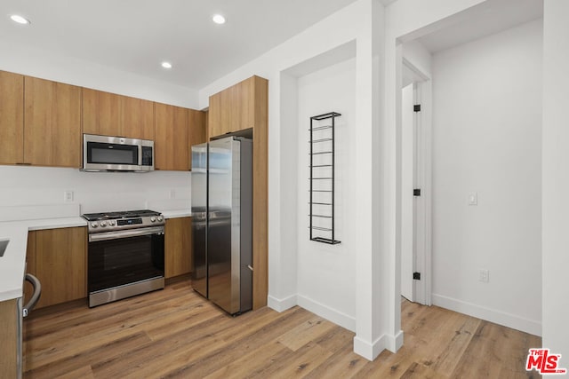 kitchen with light hardwood / wood-style flooring and stainless steel appliances