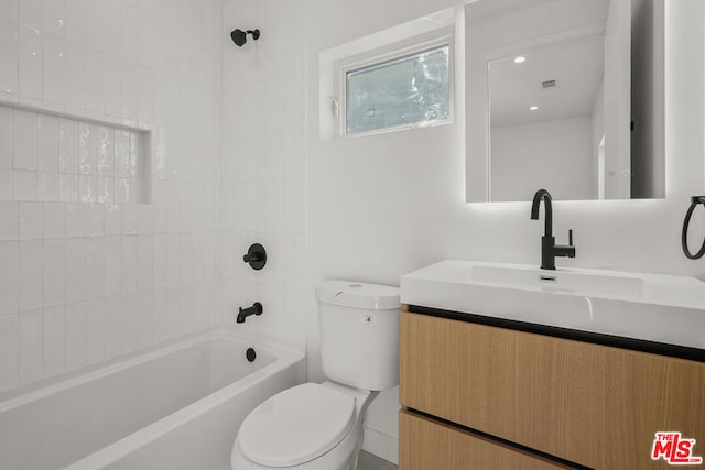 full bathroom featuring vanity, toilet, and tiled shower / bath combo