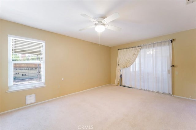 empty room with light carpet and ceiling fan