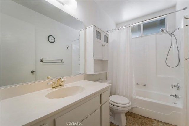 full bathroom featuring toilet, vanity, and shower / tub combo with curtain