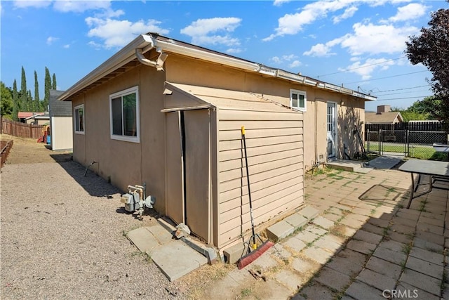 view of property exterior with a patio