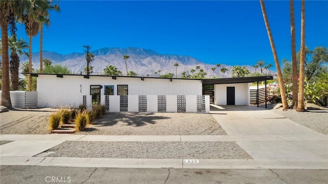 view of front of house featuring a mountain view and a carport