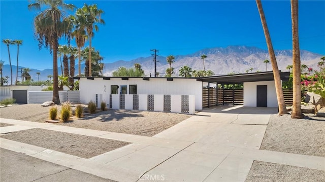 contemporary home featuring a carport and a mountain view