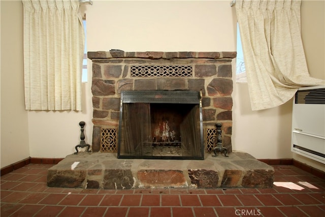 details featuring heating unit and a fireplace