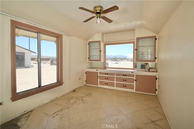 interior space featuring vaulted ceiling and ceiling fan