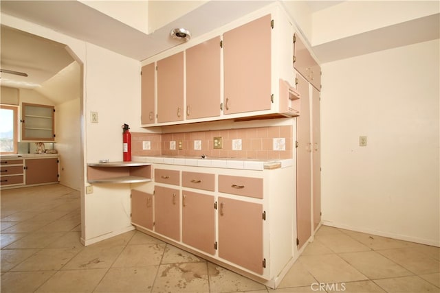 kitchen featuring decorative backsplash and light tile patterned flooring