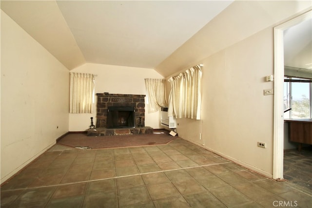 unfurnished living room with lofted ceiling and a fireplace