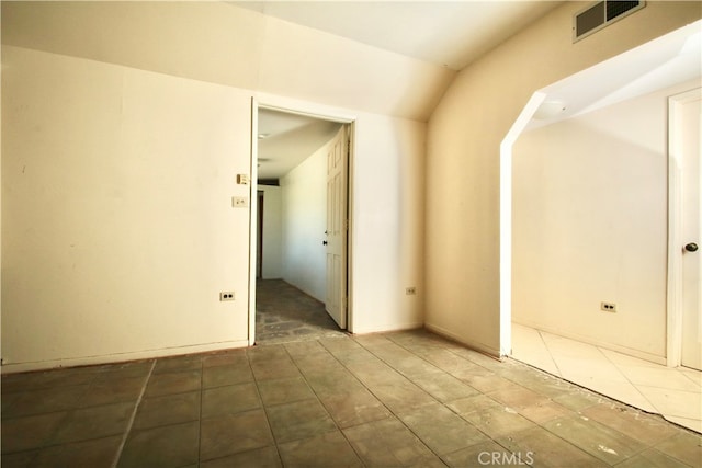 spare room with lofted ceiling