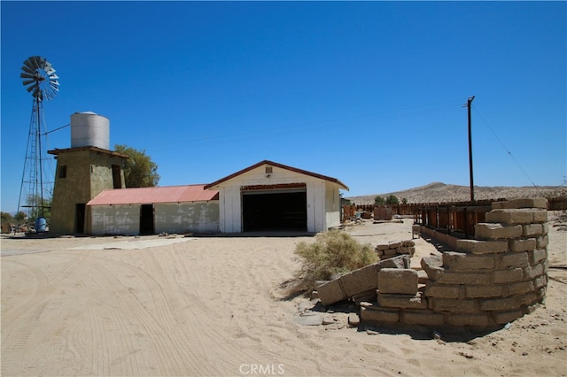 view of front of property featuring an outbuilding and a garage