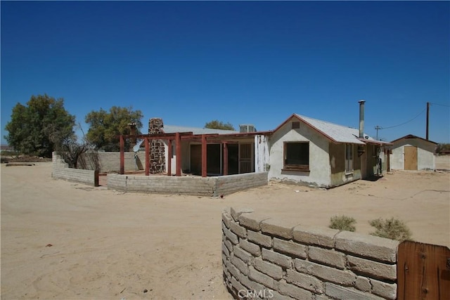 back of property featuring stucco siding