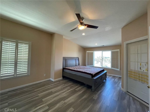 bedroom with a textured ceiling, ceiling fan, lofted ceiling, and dark wood-type flooring