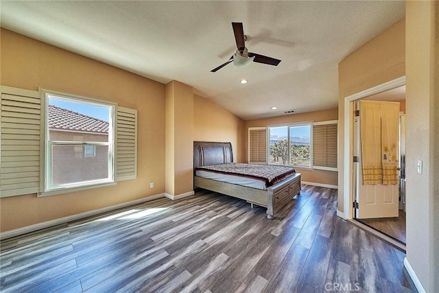 unfurnished bedroom with a textured ceiling, dark hardwood / wood-style floors, ceiling fan, and lofted ceiling