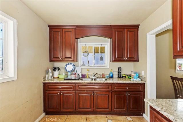 bar with sink and light stone countertops