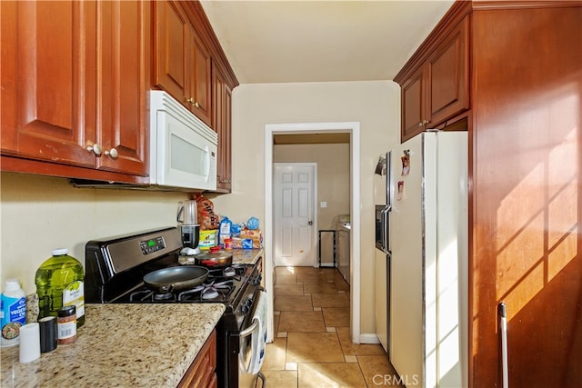 kitchen with light stone counters and white appliances