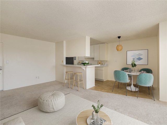 living room with light colored carpet and a textured ceiling