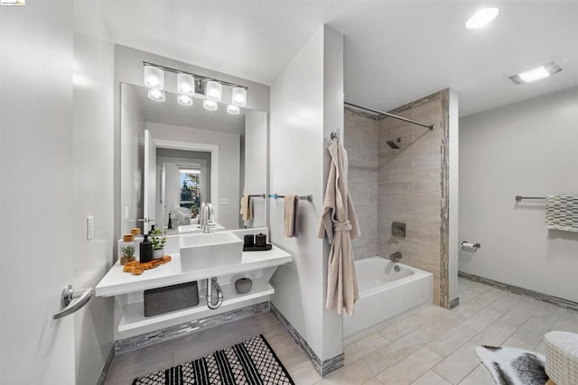 bathroom with vanity and tiled shower / bath combo