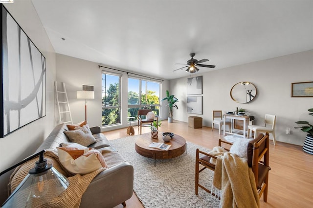 living room with light hardwood / wood-style floors and ceiling fan