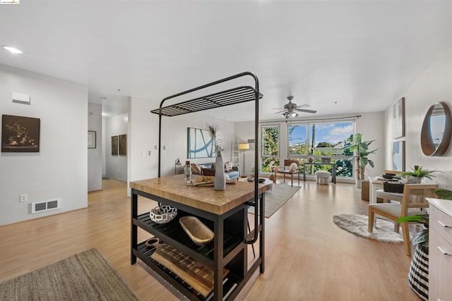 dining area featuring light hardwood / wood-style floors, floor to ceiling windows, and ceiling fan