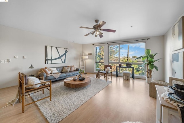 living room with light hardwood / wood-style floors and ceiling fan