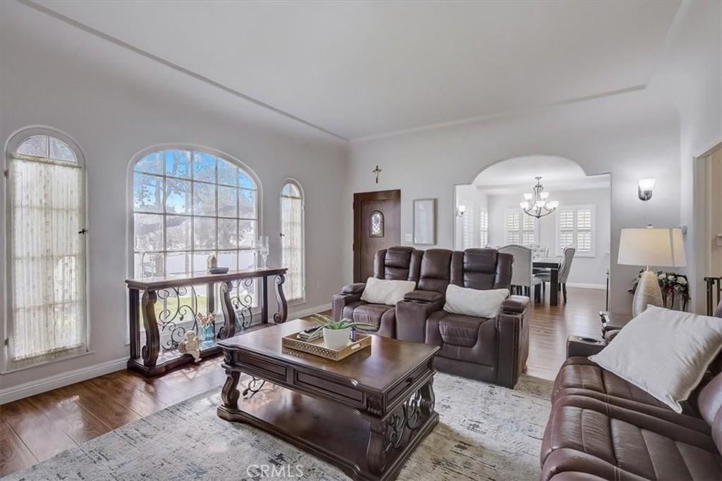 living room with hardwood / wood-style flooring and a chandelier