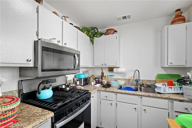 kitchen with white cabinetry, stainless steel appliances, and sink