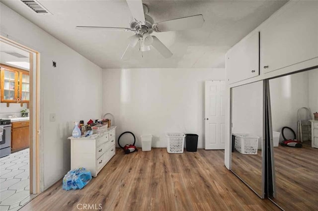 interior space with ceiling fan and light hardwood / wood-style floors